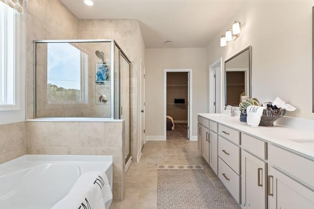 bathroom featuring tile patterned floors, vanity, and plus walk in shower