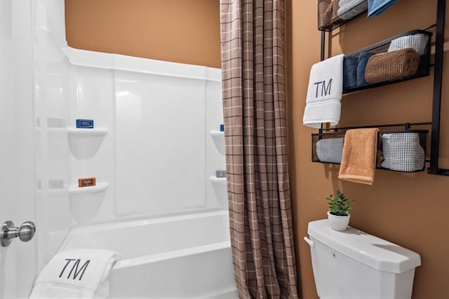 bathroom featuring toilet and shower / bath combination with curtain