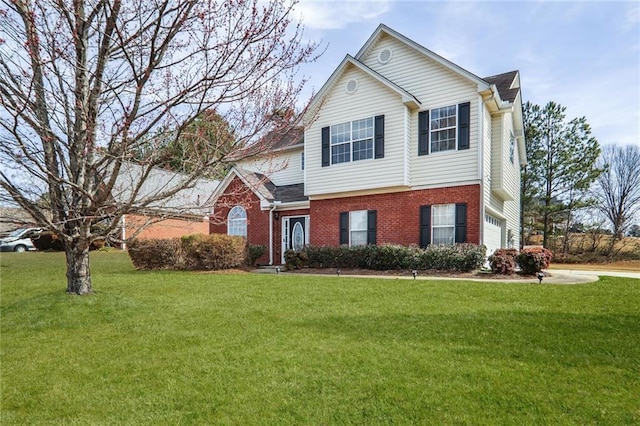 view of front of property with brick siding, an attached garage, and a front yard