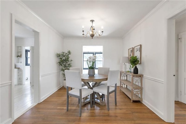 1631 Dresden Dr NE, Brookhaven, GA 30319 - dining room featuring a chandelier, wood finished floors, and crown molding