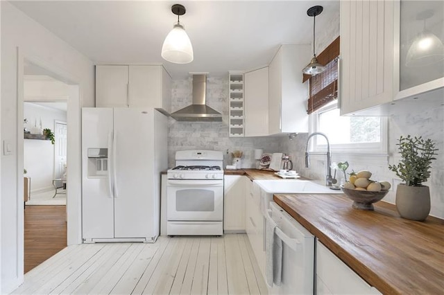 1631 Dresden Dr NE, Brookhaven, GA 30319 - kitchen featuring wall chimney exhaust hood, white appliances, wood counters, light wood finished floors, and decorative backsplash