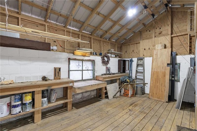 1631 Dresden Dr NE, Brookhaven, GA 30319 - miscellaneous room with light wood-type flooring, a workshop area, high vaulted ceiling, and wooden walls