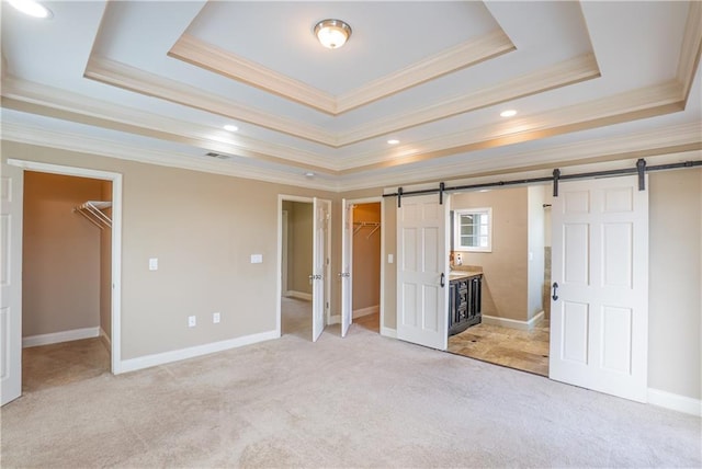 1137 Fortress Ave SW, Atlanta, GA 30315 - unfurnished bedroom featuring a spacious closet, a barn door, and a tray ceiling