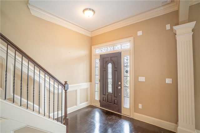 1137 Fortress Ave SW, Atlanta, GA 30315 - foyer featuring dark wood-style floors, ornate columns, stairs, wainscoting, and crown molding
