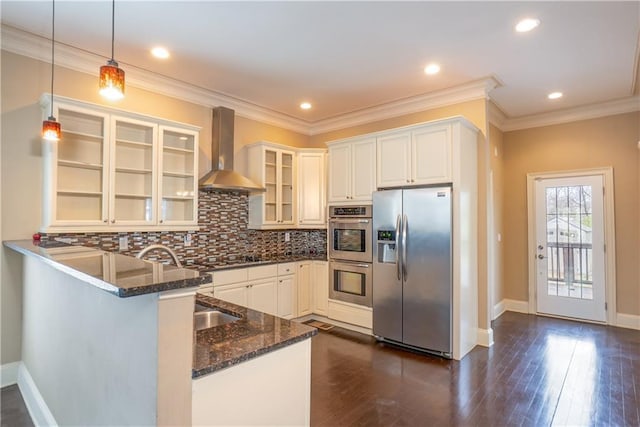 1137 Fortress Ave SW, Atlanta, GA 30315 - kitchen featuring glass insert cabinets, dark stone counters, a peninsula, stainless steel appliances, and wall chimney exhaust hood