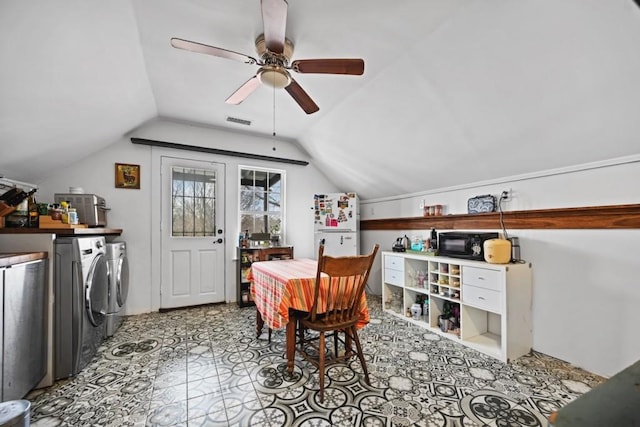 dining space featuring lofted ceiling, washing machine and clothes dryer, and ceiling fan