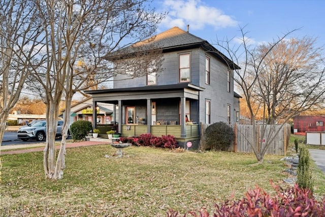 view of front of home with a front yard and a porch