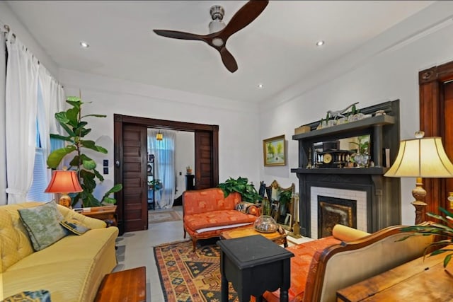 living room featuring a fireplace and ceiling fan