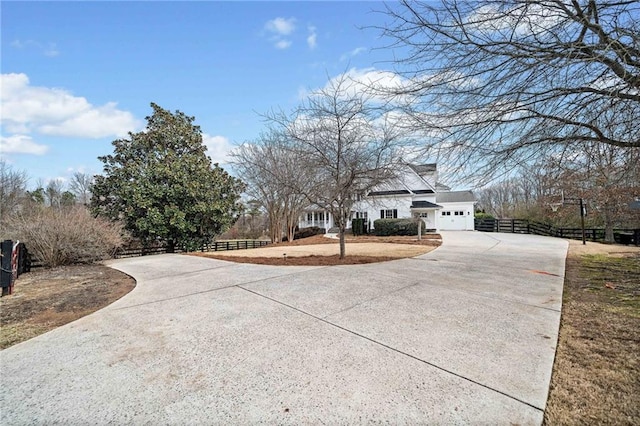 view of street with concrete driveway