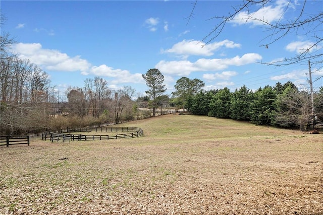 view of yard featuring fence and a rural view