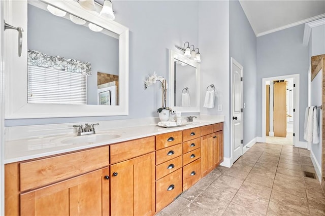 bathroom with crown molding, a sink, visible vents, and double vanity