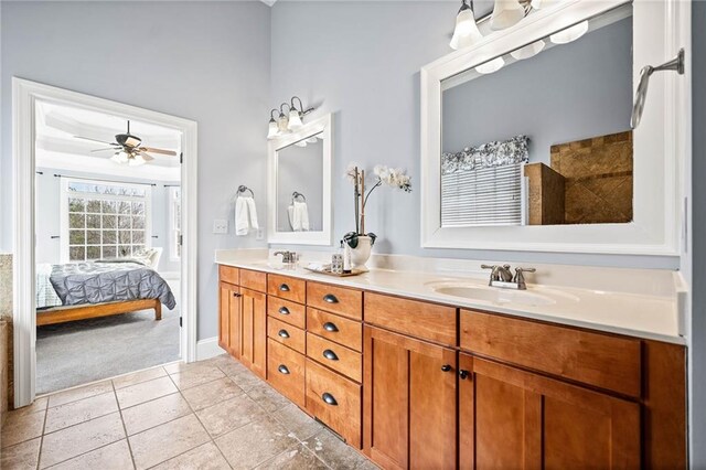 ensuite bathroom featuring a ceiling fan, a sink, double vanity, and ensuite bathroom