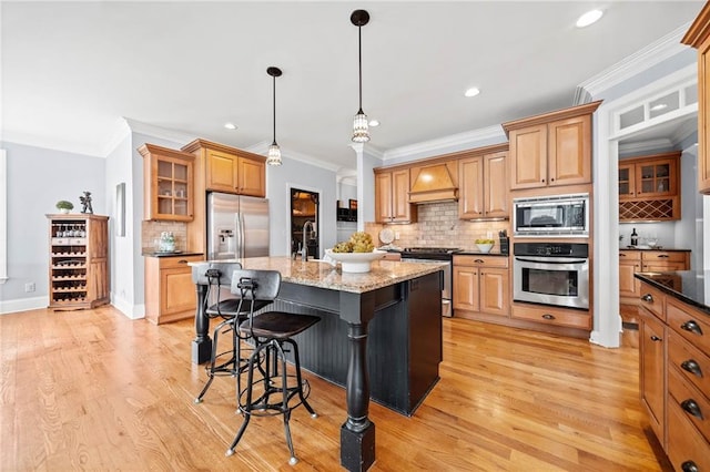 kitchen featuring stainless steel appliances, custom exhaust hood, recessed lighting, backsplash, and a breakfast bar area