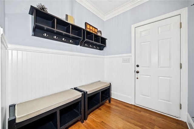 mudroom with wood finished floors, crown molding, and a wainscoted wall