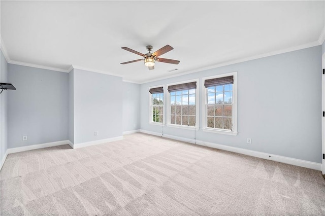 unfurnished room with ornamental molding, baseboards, ceiling fan, and light colored carpet