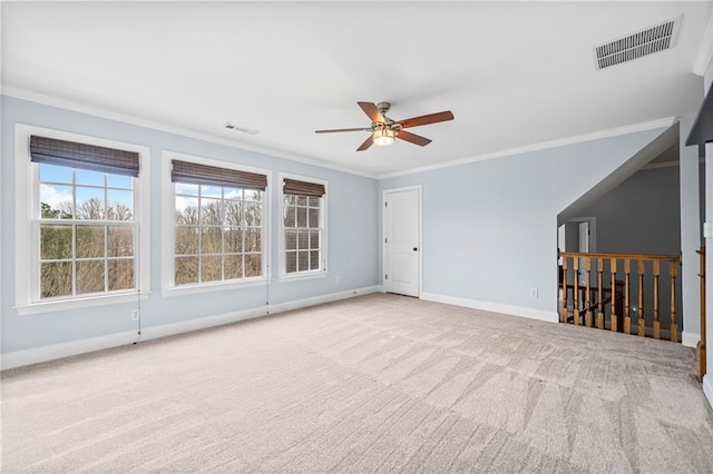 empty room featuring carpet, visible vents, baseboards, and ceiling fan