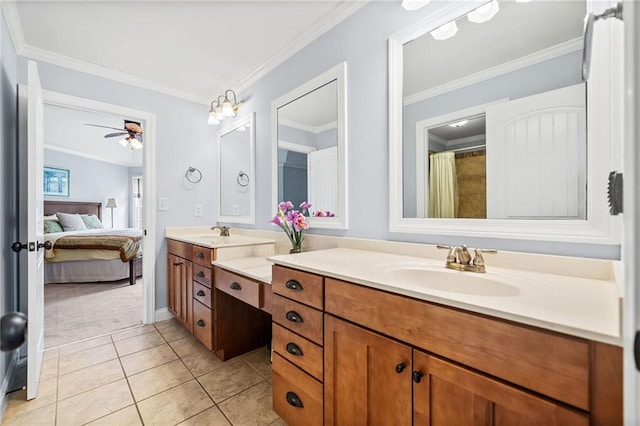 ensuite bathroom with a ceiling fan, ornamental molding, a sink, and double vanity