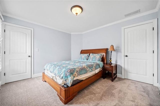carpeted bedroom with baseboards, crown molding, and visible vents