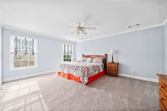 carpeted bedroom featuring a ceiling fan, baseboards, ornamental molding, and visible vents
