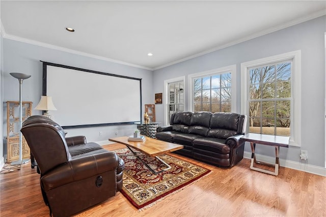 home theater with recessed lighting, wood finished floors, baseboards, and ornamental molding