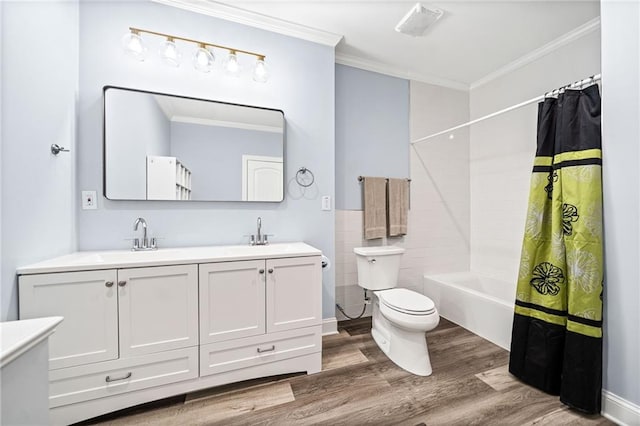 bathroom featuring wood finished floors, toilet, ornamental molding, and a sink