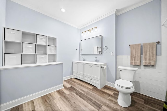 full bath with wood finished floors, crown molding, tile walls, and toilet