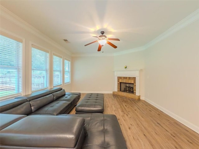 750 Summerstone Ln, Lawrenceville, GA 30044 - living room featuring light wood-type flooring, ceiling fan, baseboards, ornamental molding, and a fireplace