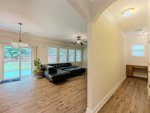 750 Summerstone Ln, Lawrenceville, GA 30044 - living room featuring crown molding, light wood-style floors, baseboards, a chandelier, and a ceiling fan