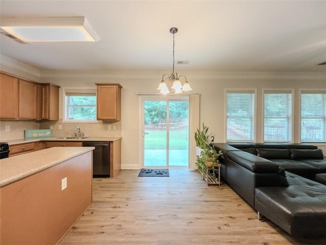 750 Summerstone Ln, Lawrenceville, GA 30044 - kitchen featuring dishwashing machine, a sink, light wood-type flooring, a chandelier, and light countertops