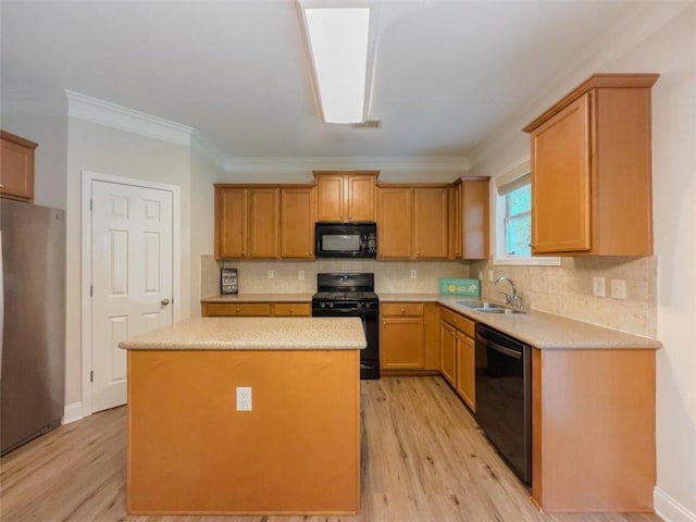 750 Summerstone Ln, Lawrenceville, GA 30044 - kitchen featuring black appliances, a sink, light wood-type flooring, a center island, and ornamental molding