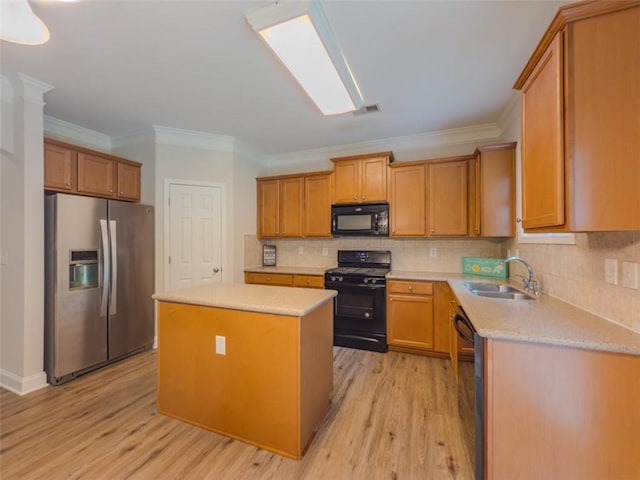750 Summerstone Ln, Lawrenceville, GA 30044 - kitchen with black appliances, a center island, light wood finished floors, light countertops, and ornamental molding
