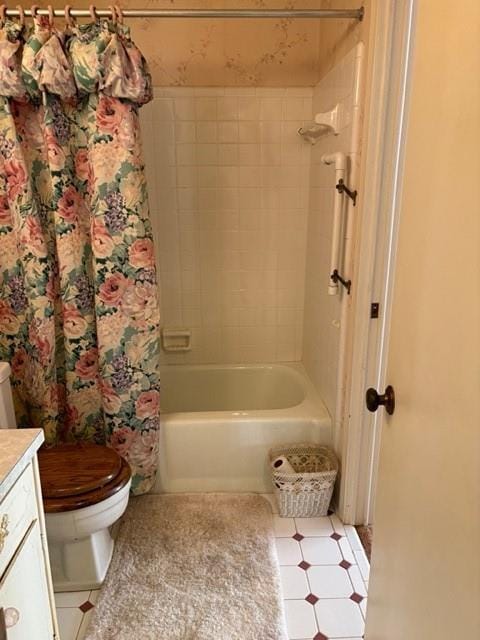 full bathroom with tiled shower / bath combo, vanity, and toilet