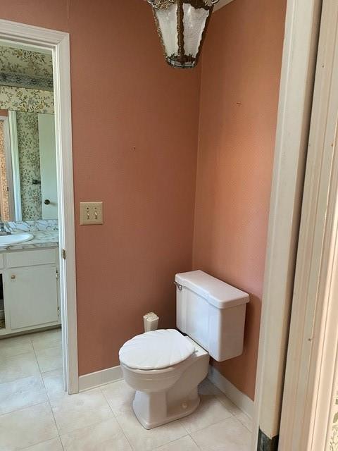 bathroom with vanity, toilet, and tile patterned flooring