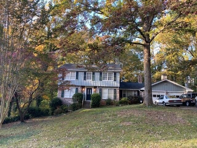 colonial house with a garage and a front yard