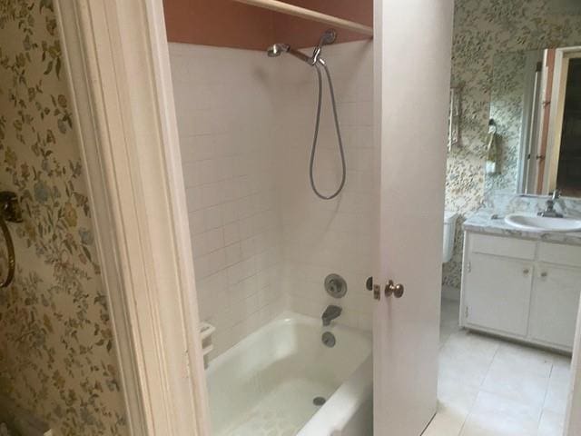 bathroom with vanity, tile patterned flooring, and tiled shower / bath combo