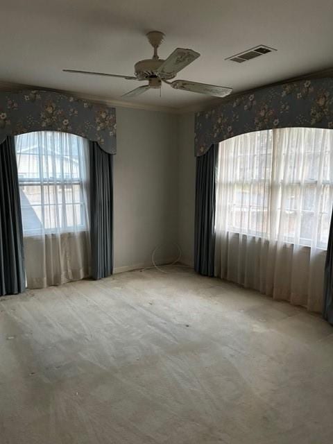 spare room featuring ceiling fan and ornamental molding