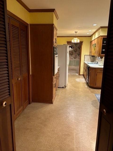 hallway featuring ornamental molding and sink