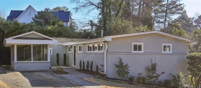 back of house featuring a sunroom