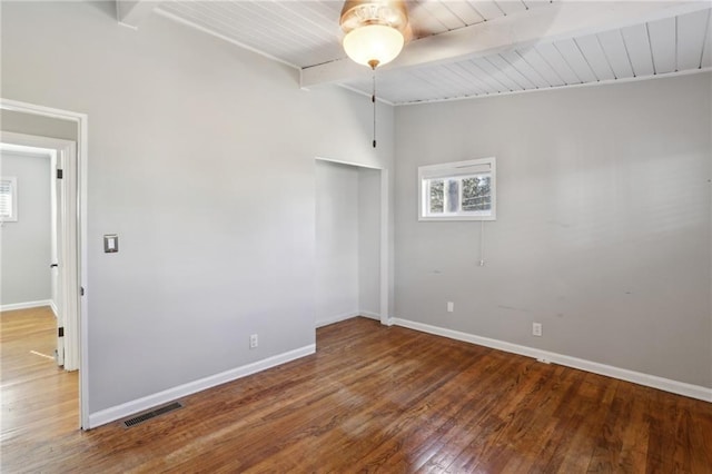 spare room with wood ceiling, beam ceiling, and hardwood / wood-style flooring