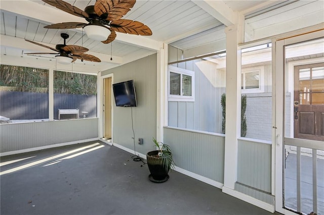 unfurnished sunroom featuring beam ceiling