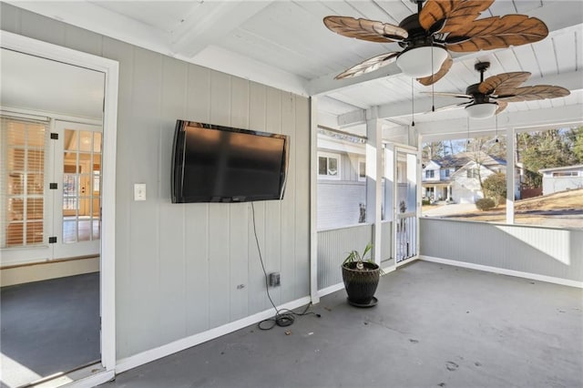 unfurnished sunroom with beamed ceiling and ceiling fan