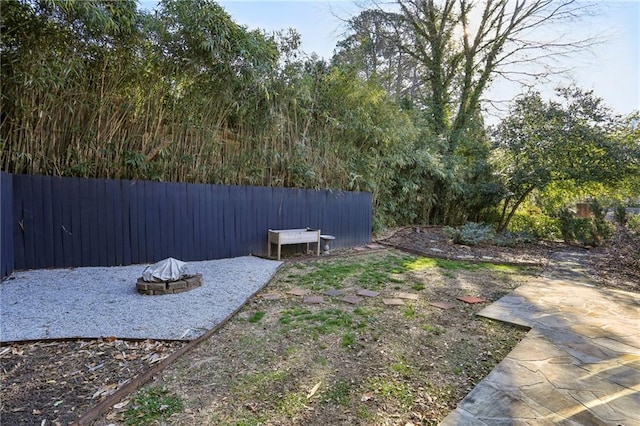 view of yard with an outdoor fire pit and a patio