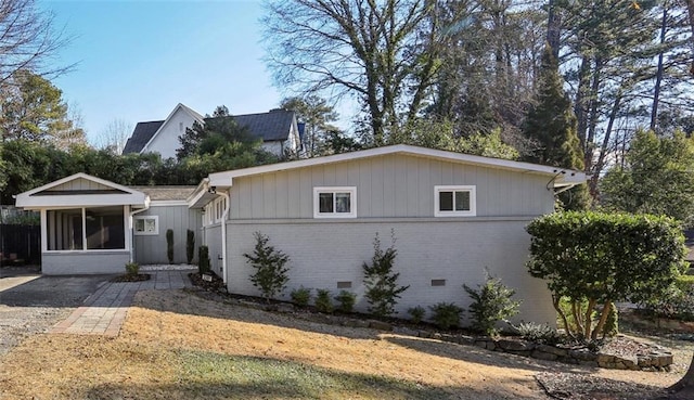 view of front of home featuring a sunroom