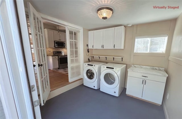 laundry area featuring cabinets and washer and clothes dryer