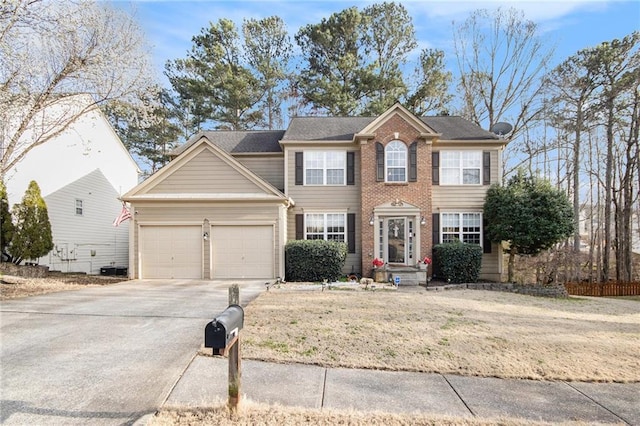 colonial home with a front yard, an attached garage, brick siding, and driveway