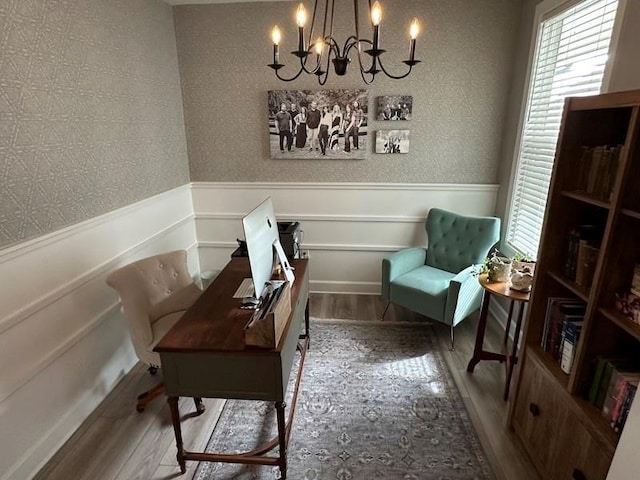 living area featuring hardwood / wood-style flooring and a notable chandelier