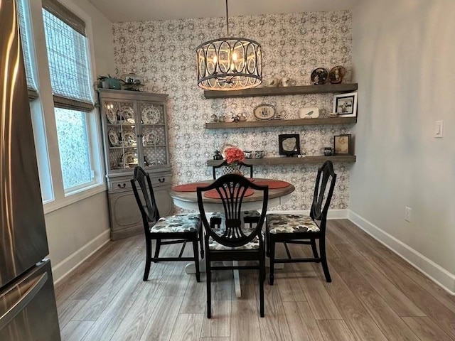 dining area featuring hardwood / wood-style flooring, plenty of natural light, and a notable chandelier