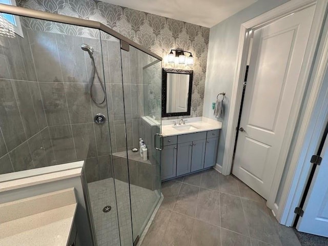 bathroom with tile patterned floors, vanity, and an enclosed shower