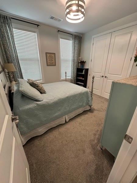 carpeted bedroom with a closet