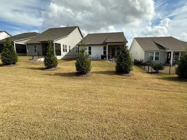 rear view of house with a yard